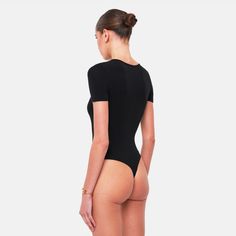 The ROSA Bodysuit is the perfect basic, crafted from an ultra-soft fabric blend that hugs your body flawlessly. Designed for both comfort and style, this bodysuit provides a sleek, form-fitting silhouette, making it an essential piece for any wardrobe.Size and fit:• The bodysuit runs small; we suggest sizing upInfo:• 48% cotton, 48% modal, 4% spandex• Gusset hook and eye closure with thong back• Machine wash (mild detergent, iron, no bleaching, dry flat, do not tumble dry)Model info:• 5' 10"/177 Arm Sleeve, Hug You, Black Bodysuit, Sleek, Soft Fabrics, Spandex, Fabric, Black