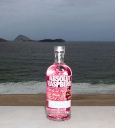 a bottle of absolut raspberry gin on the beach