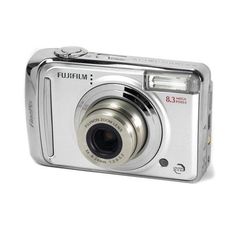 a silver digital camera sitting on top of a white surface