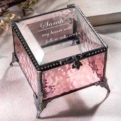 a pink glass box with a poem on it