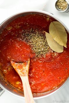 a pot filled with sauce and spices on top of a table