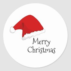 a round sticker with a santa claus hat on it's back and merry christmas written across the top