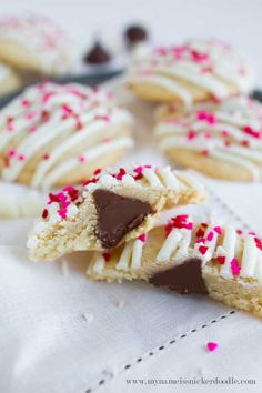 some cookies with white and red sprinkles on them