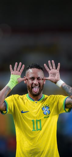 a soccer player with his hands in the air