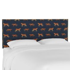 an upholstered headboard with horses in orange and brown on a blue background