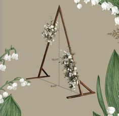 a triangle with flowers hanging from it's sides on a wall next to lily of the valley