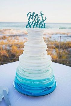 a white and blue cake sitting on top of a table