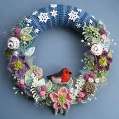 a knitted wreath with a bird on it