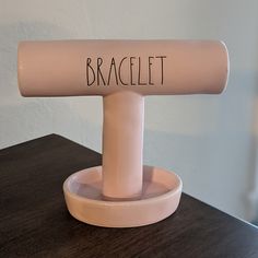 a pink object with the word braclet written on it sitting on a table