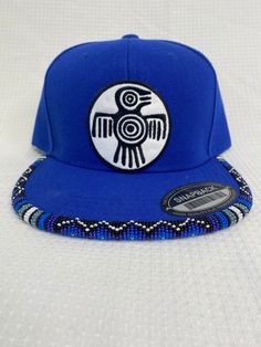 You are viewing a hand-beaded baseball hat with thunderbird patch. The hat is ADULT size. All beads are sewn by hand.  All patches are applied by hand. No two hats are exactly alike and will never be replicated exactly. Made by an indigenous artist, I am an enrolled member of the Jumano Nation of West Texas. Free shipping to US locations only Beaded Baseball Cap Patterns, Traditional Adjustable Snapback Hat, Adjustable Flat Bill Snapback Hat For Festival, Festival Snapback Hat With Flat Bill, Traditional Adjustable Snapback Baseball Cap, Beaded Hat Brim, Metis Beadwork Patterns, Metis Beadwork, Bead Hat