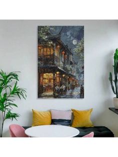 a living room filled with furniture and a painting on the wall over a white table