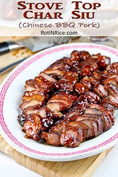 a white plate topped with ribs covered in bbq sauce next to a cutting board