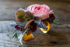 a bouquet of flowers sitting on top of a wooden table