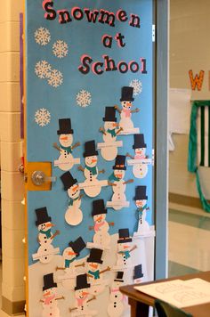 a bulletin board with snowmen at school written on it and hanging from the wall