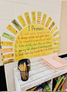 a bulletin board with writing on it in front of a book shelf filled with children's books