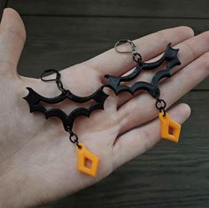 These earrings are lightweight with a black bat symbol and orange ornament to represent the Halloween aesthetic during the season and outside of the season! Comes as two fully assembled Custom modeled 3d printed earrings with lever back hooks. Dimensions (cm): Length: 5.15 Height: 8.5 Width: 0.45 Orange Ornaments, 3d Printed Earrings, Printed Earrings, Bat Symbol, Halloween Pendant, Bat Earrings, Halloween Lovers, Halloween Aesthetic, Black Bat