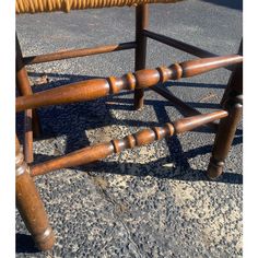 an old wooden chair sitting on the ground