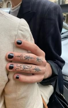 a woman's hand with tattoos on it