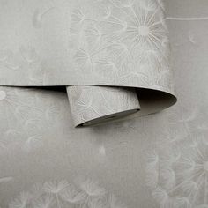 two sheets with white flowers on them next to each other