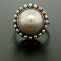 You are looking at a beautiful, antique, mabé pearl ring & earrings set. The set is crafted in solid 10k rose gold and it still has its original patina preserved which can be polished to like new if desired. The design shows the mabé pearl bezel set in the center of the setting surrounded with a prong set seed pearl bezel on all 3 pieces. We can sell you any piece individually if you desire. Enjoy! -- Item Details -- Material: 10k Solid Rose Gold Weight: 18.3 Grams -- Stone(s): (3) Natural G Victorian Oval Cabochon Pearl Ring, Heirloom Round Pearl Drop Jewelry, Antique Pearl Ring With Cabochon For Anniversary, Antique Cabochon Pearl Ring For Anniversary, Antique Pearl Ring With Cabochon For Formal Occasions, Antique Pearl Ring With Cabochon For Formal Events, Victorian Screw Back Wedding Jewelry, Vintage Cabochon Pearl Ring For Wedding, Vintage Round Pearl Drop Jewelry