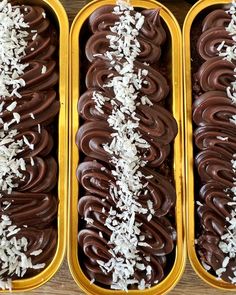 three trays filled with chocolate covered donuts