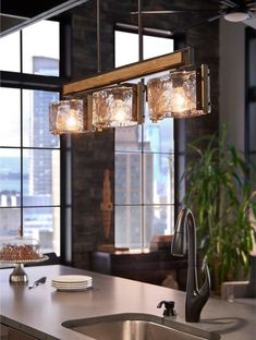 a kitchen light hanging over a sink next to a window