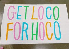 someone holding up a sign that says get locoo forhoo on the ground