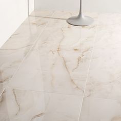 a bathroom with marble flooring and white walls