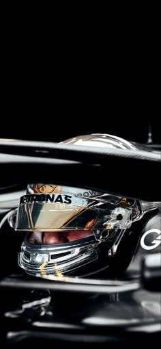 the front end of a racing car with its reflection in it's side mirror