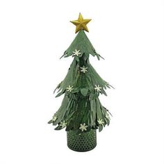 a small green christmas tree with white flowers on it's top and gold star