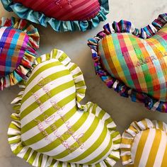 four decorative heart shaped pillows on a table