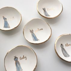 four personalized porcelain dishes with dresses on them