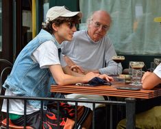 an older man and young woman sitting at a table