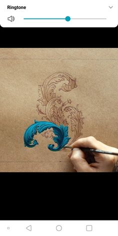 someone is drawing something on paper with colored pencils