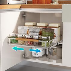 the kitchen cabinet door is open to show spices and other items in containers on shelves