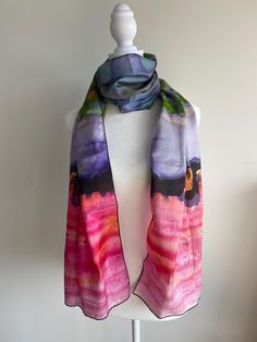 Dramatic peach, pink, purple, and blue, scarf in silk or poly chiffon features a tie dye pattern of inspired by one of my one of a kind paintings.  It comes in two lengths 45" and 72". The 72 inch scarf is long enough to knot and wrap almost any way you wish.  A note on the color: The poly chiffon is translucent. Color can vary depending on  the color of the clothing underneath, or how the scarf overlaps. * Three Fabric Options: Silk Charmeuse, Silk Habotai, and Poly Chiffon * Two sizes:  10" x 45" and 16" x 72" * Made from 100% polyester fabric or silk * Very soft hand, lovely drape * Print is visible about 50% on the back side * Each scarf is printed and sewn by hand in Montreal, Canada * Vivid print that will never fade after washing * Machine wash in cold water with phosphate free dete Purple Scarves As Summer Gifts, Summer Purple Silk Scarf As A Gift, Multicolor Hand Dyed Scarves As Gift, Pink Scarves As Gifts, Pink Silk Scarf For Summer, Purple Silk Scarf For Summer Gift, Purple Bohemian Silk Scarf As Gift, Multicolor Hand Dyed Scarves Gift, Multicolor Hand Dyed Scarf Gift