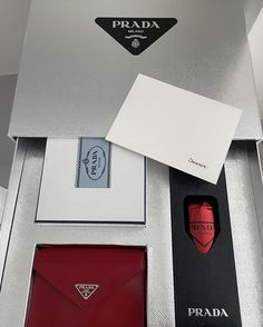 an open prada box with its contents in it