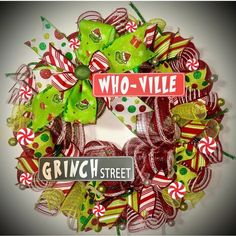 a wreath made out of candy canes and bows with the words who - vile on it