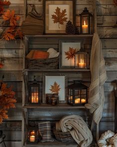 a shelf filled with candles and pictures on top of it next to other items in front of a wooden wall