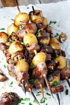 the skewers are covered with meat and potatoes