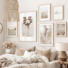 a white bedroom with pictures on the wall