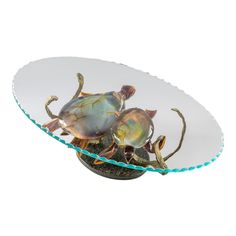 two glass crabs sitting on top of a plate