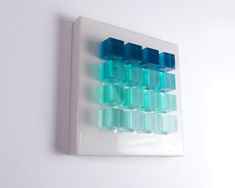 a white wall with blue and green squares on the bottom half, in front of a white background