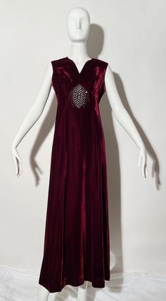 Burgundy velvet gown. Rhinestone detail. Sleeveless. Rear zipper. Lined.  *Condition: excellent vintage condition. No visible flaws. Measurements Taken Laying Flat (inches)-- Shoulder to Shoulder: 14 in. Bust: 12 in. Waist: 28 in. Hip: 32 in. Length: 53 in. Marked size: N/A, best fit for a 4/6. Sleeveless Velvet Wedding Dress, Sleeveless Velvet Dress For Wedding, Rhinestone Gown, Plaid Trousers, Velvet Gown, Vintage Icons, Burgundy Velvet, Corduroy Pants, Dress Clothes For Women