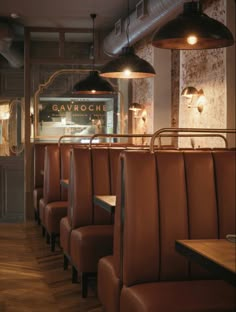 an empty restaurant with brown leather seats