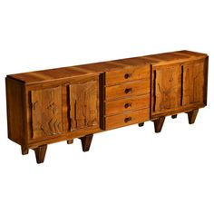 an old wooden cabinet with carvings on the doors and drawers is shown against a white background