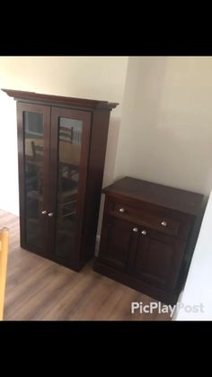 an empty room with wooden furniture and white walls