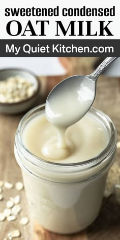 a spoon full of oatmeal sitting on top of a wooden table