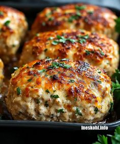 some meat patties in a pan with parsley on the top and green garnish