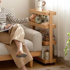 a woman sitting on a couch using a laptop computer